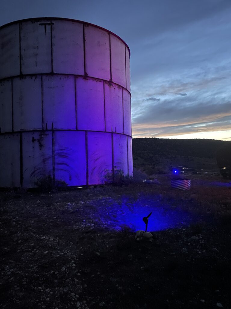 water tank at CampV lit up at night