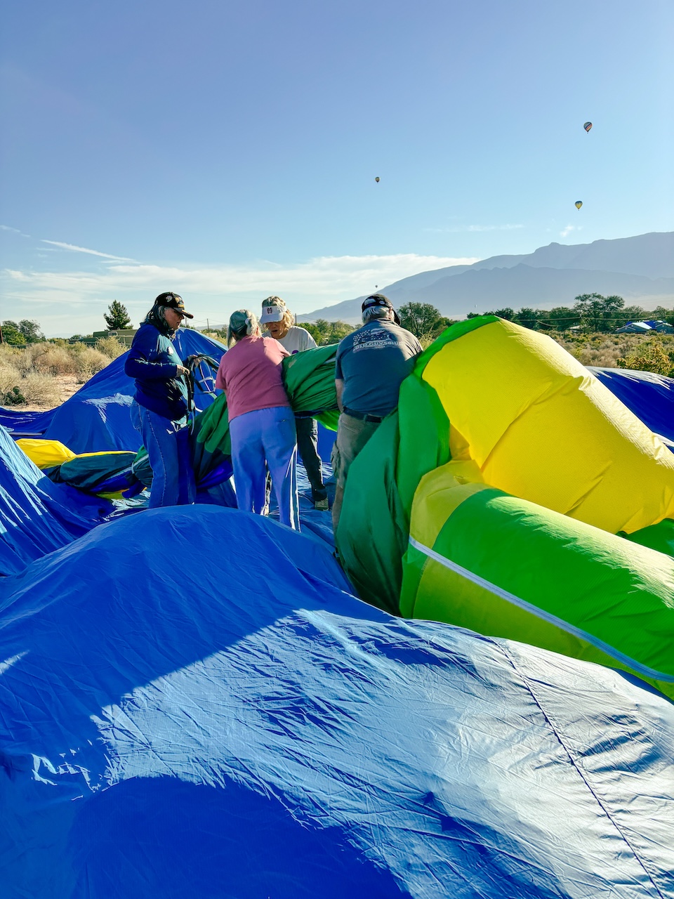 crew folding up a hot air balloon